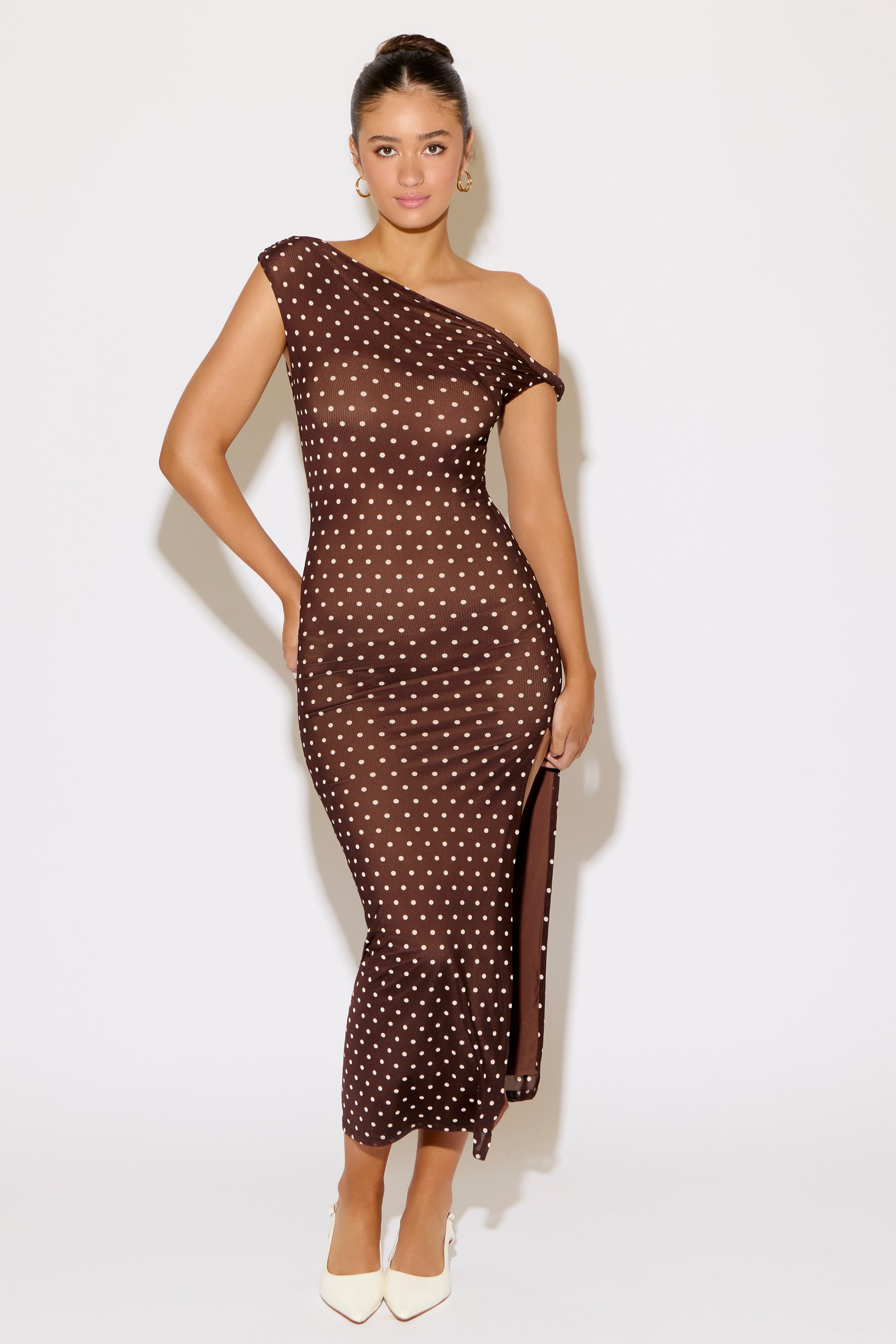 Woman wearing a polka dot dress on a white background