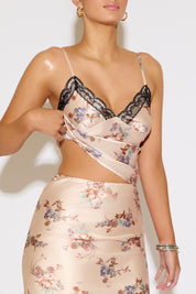 Woman wearing a floral dress with lace details on a white background