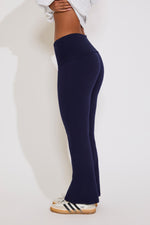 Navy blue leggings worn by a person on a white background