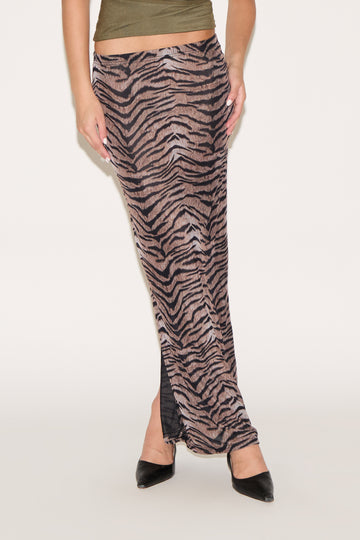 Zebra print pants worn by a person on a white background