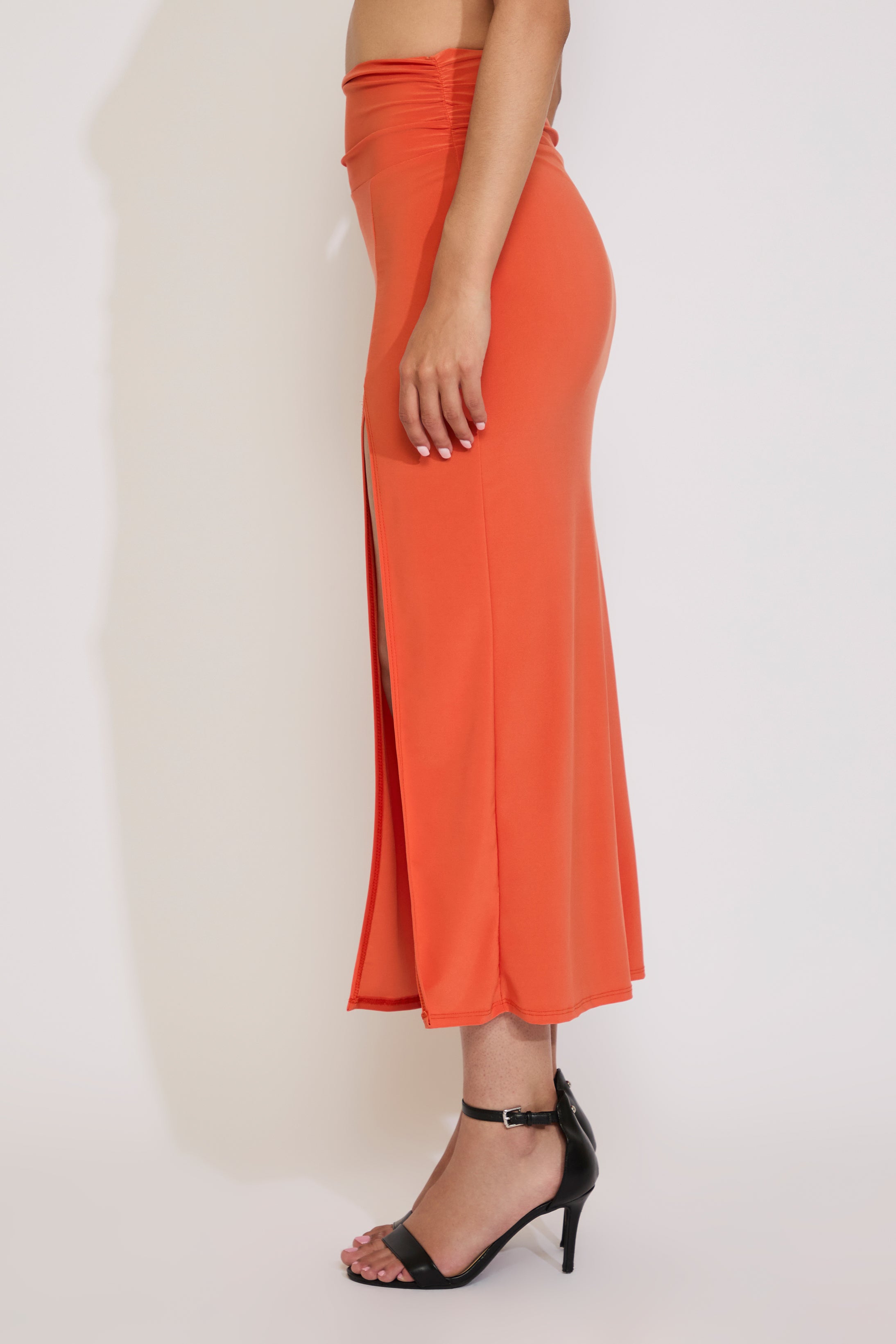 Orange dress with a slit on a white background