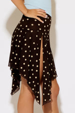 Black polka dot skirt with a high-low hem on a white background