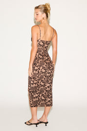 Woman wearing a patterned dress on a white background