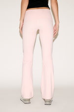 Light pink pants worn by a person on a white background