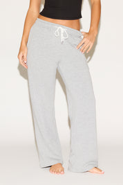 Person wearing gray sweatpants with a white background