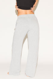Light gray sweatpants worn by a person on a white background