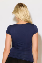 Model is wearing a navy square neck slim fit cap sleeve top with black shorts.