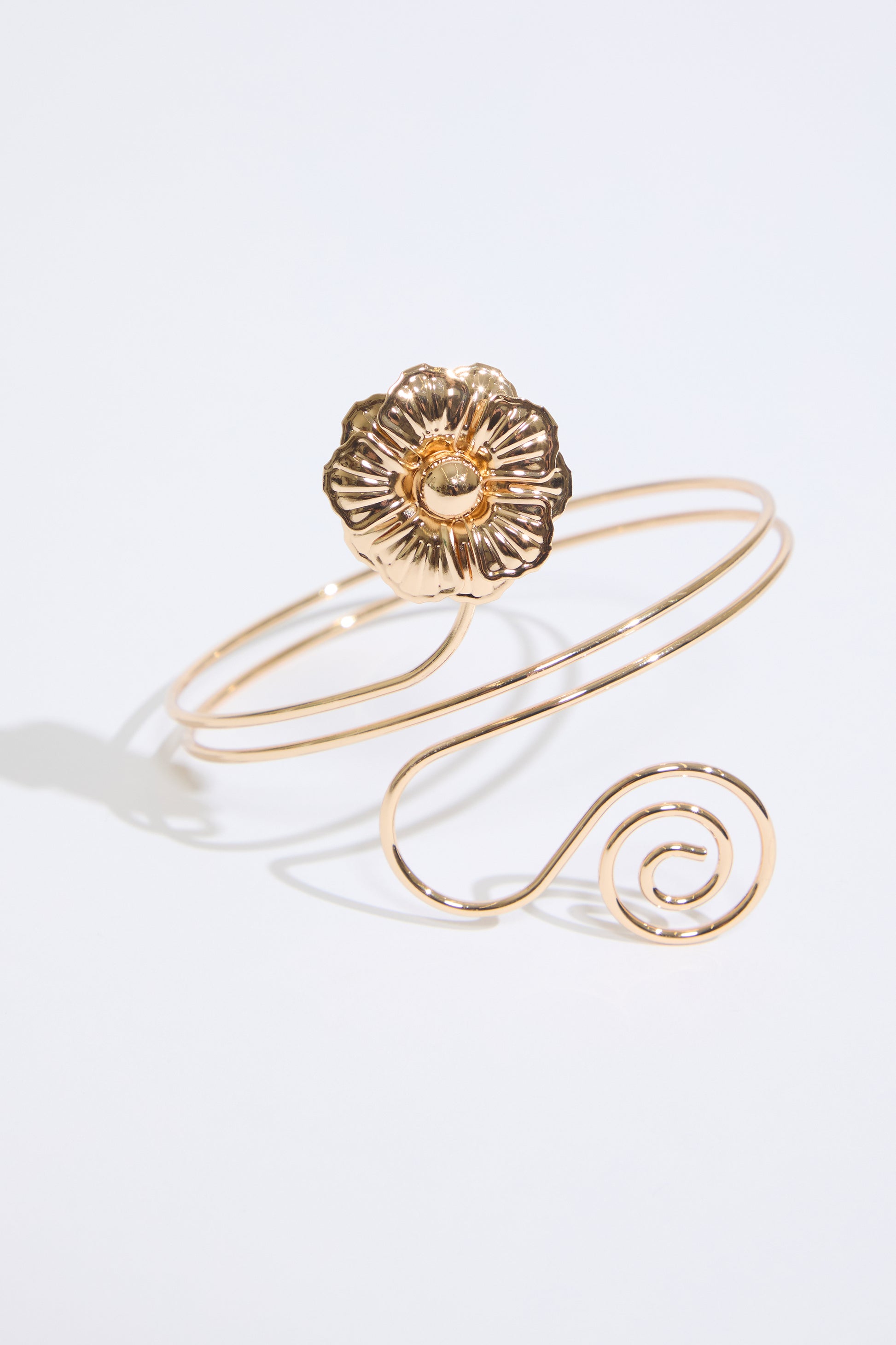 GOLD FLOWER & SWIRL METAL ARM CUFF on a white background.