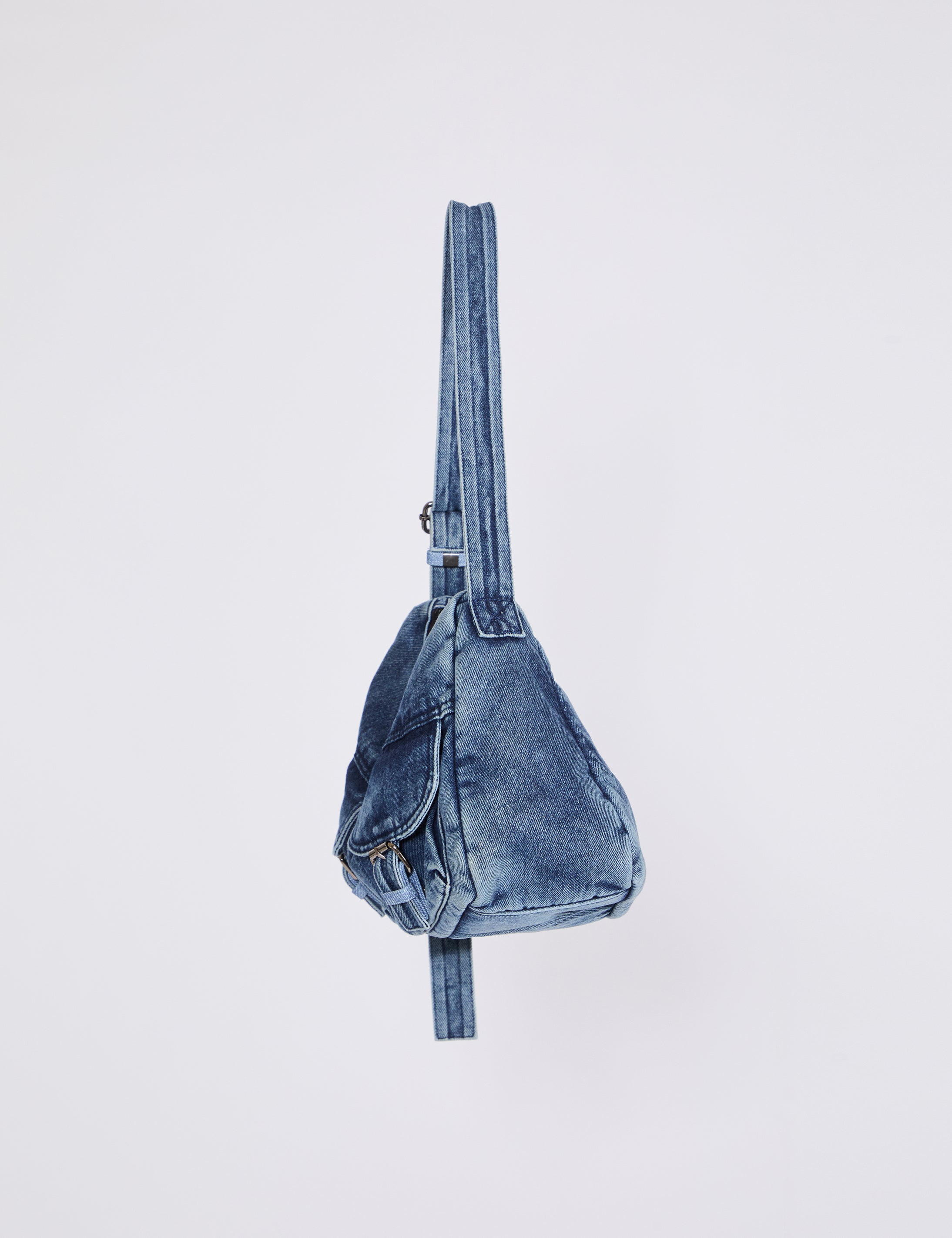 Blue denim crossbody bag on a light gray background