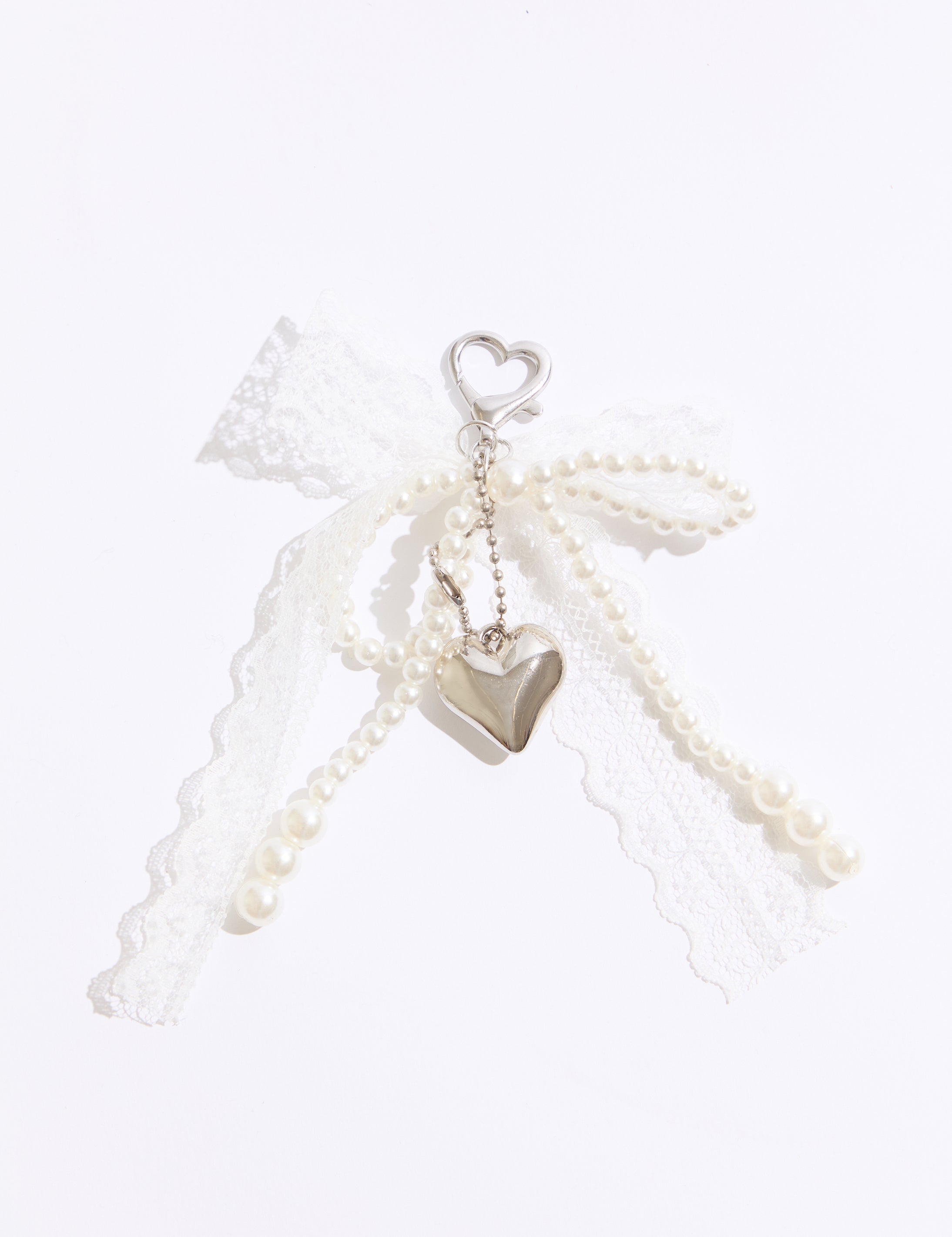Pearl necklace with heart-shaped pendants on a white background
