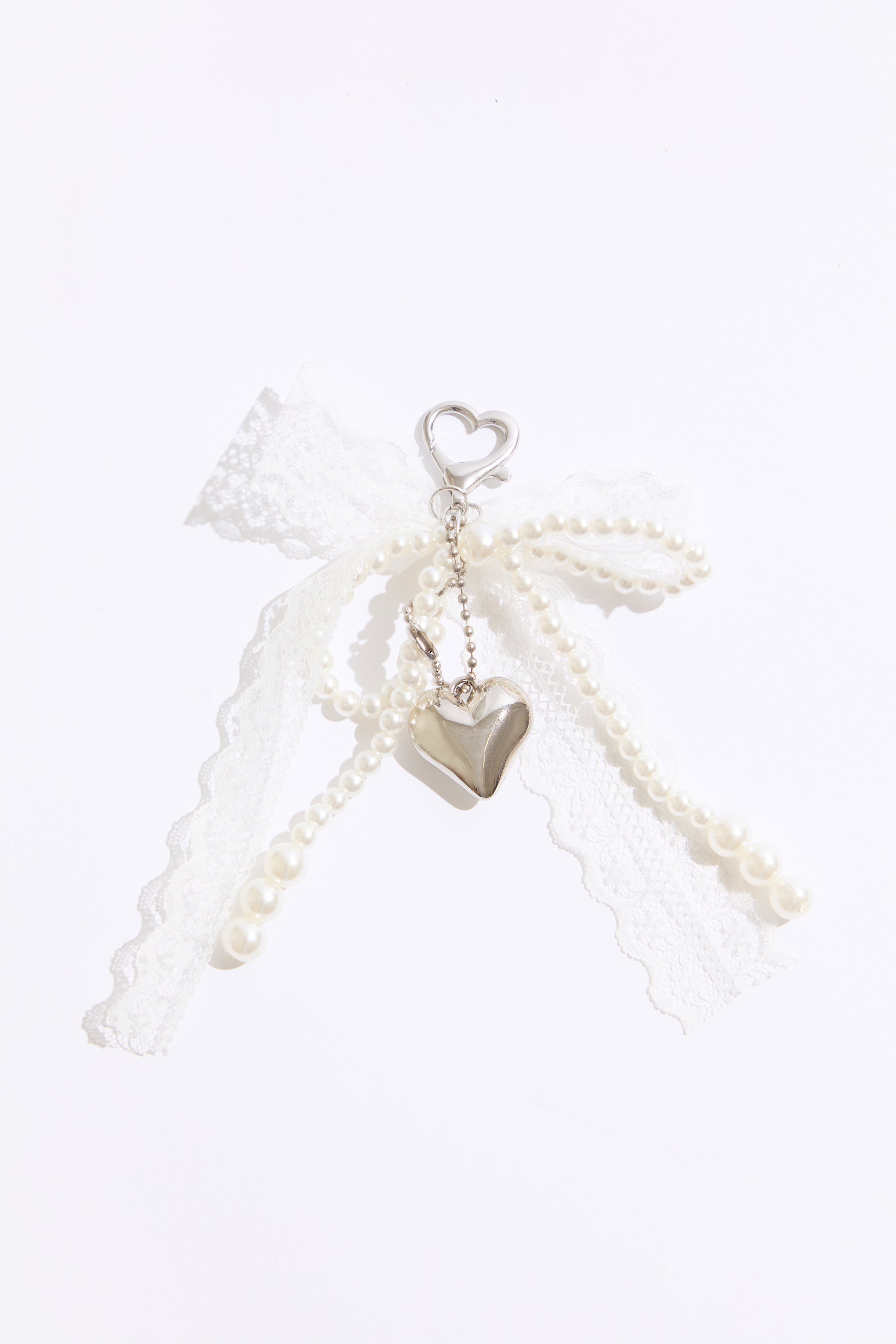 Pearl necklace with heart-shaped pendants on a white background
