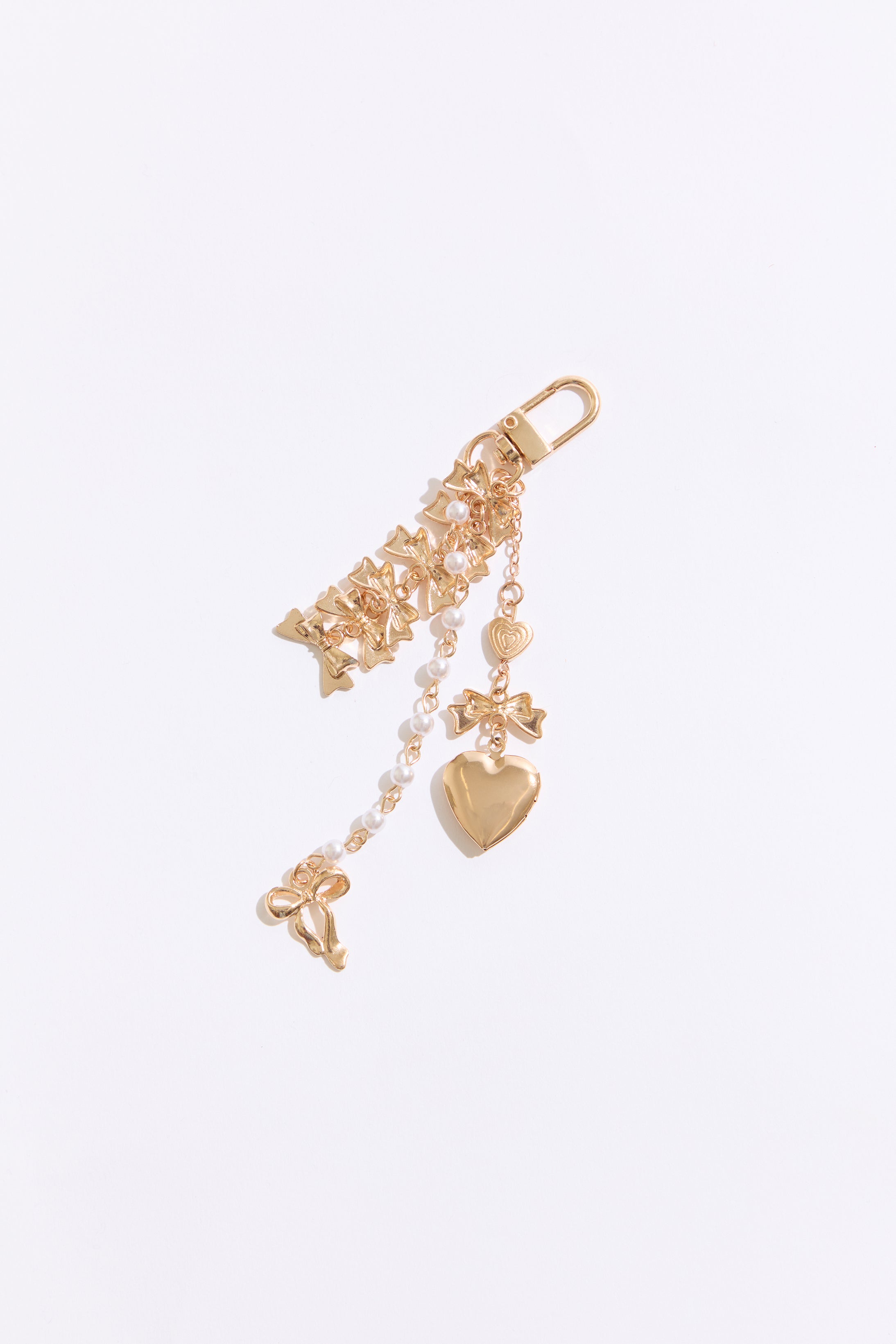 Gold keychain with heart charm on a white background