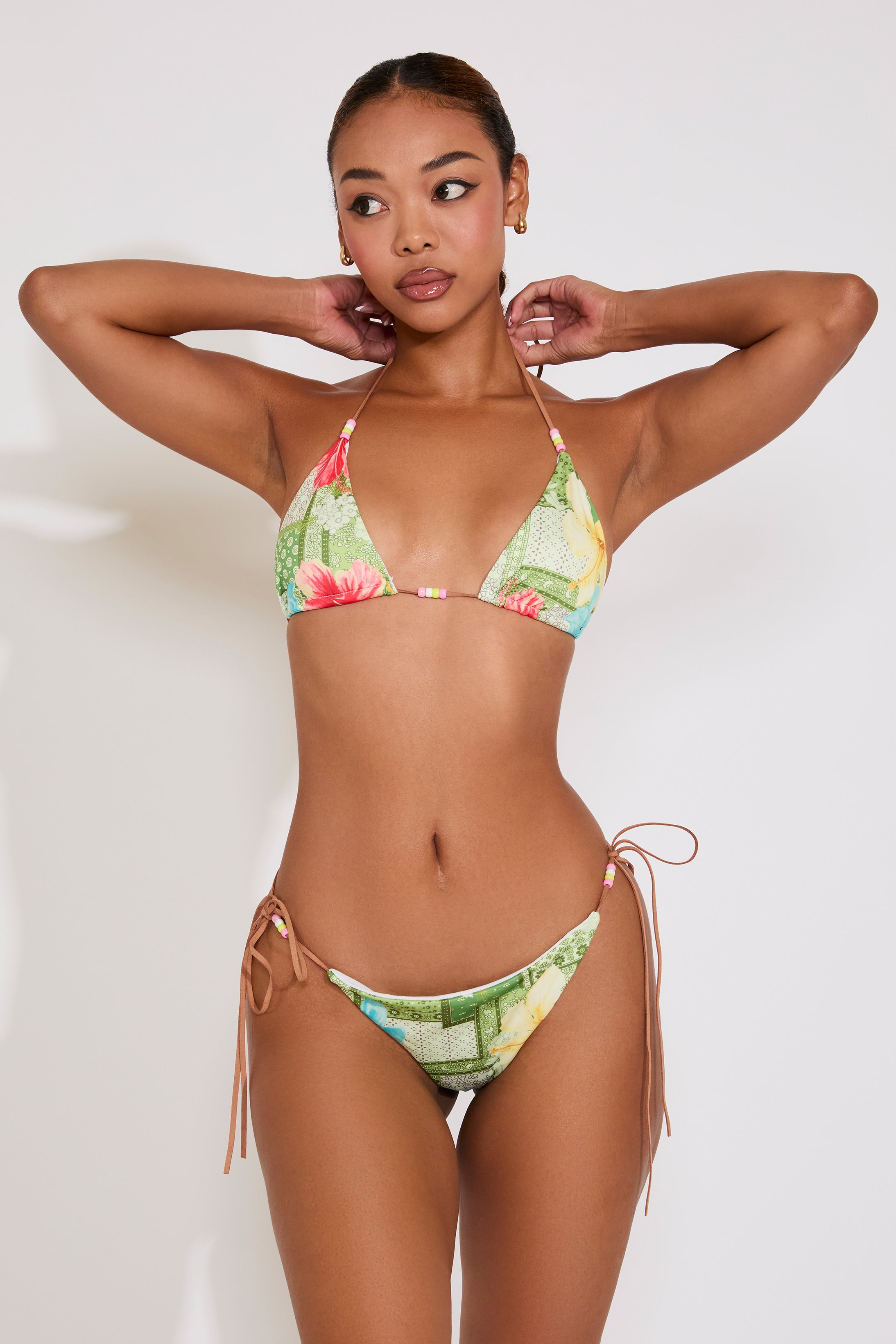 Woman wearing a colorful bikini against a white background