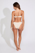 Model is wearing a peach SEASHELL DETAIL SMOCKED STRAPLESS BIKINI SET on a white background.