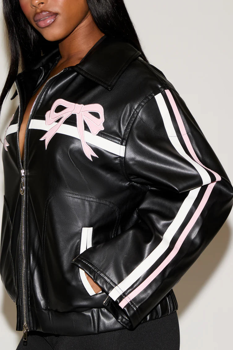 Black leather jacket with pink and white accents worn by a model against a plain background