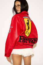 Person wearing a red Ferrari jacket with a white background
