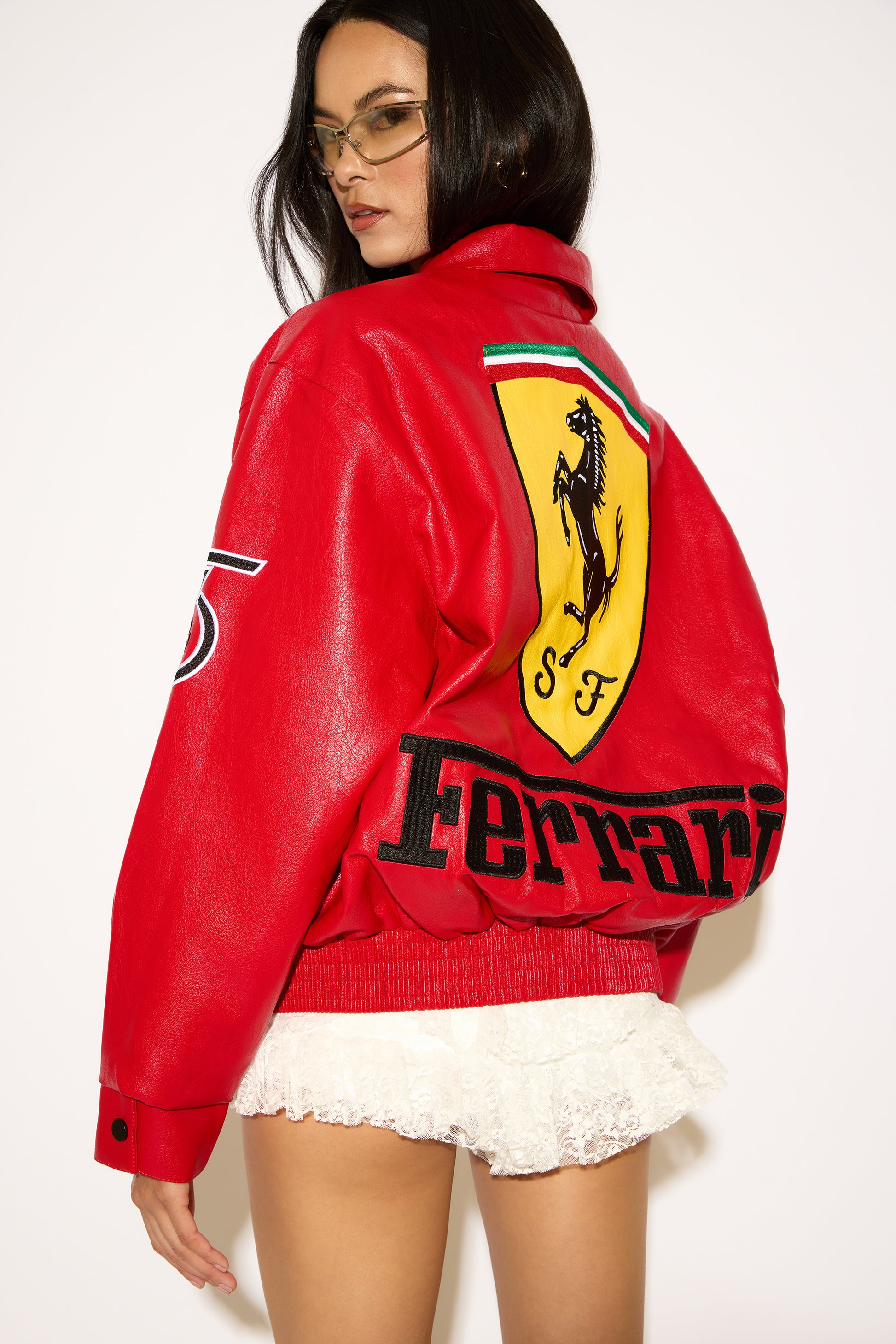 Person wearing a red Ferrari jacket with a white background