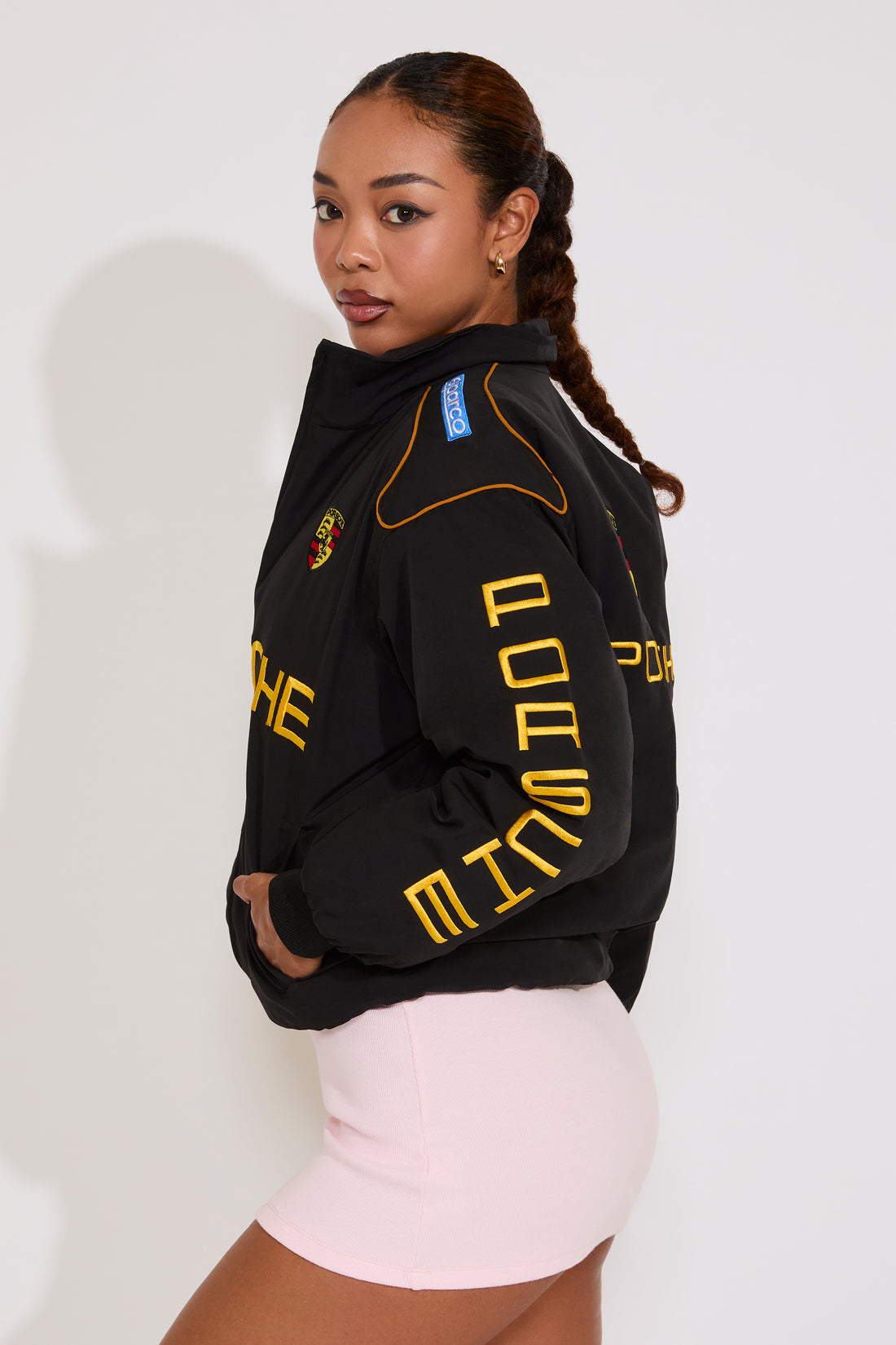 Woman wearing a black jacket with yellow text on a white background