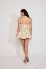 Woman wearing a floral dress on a white background