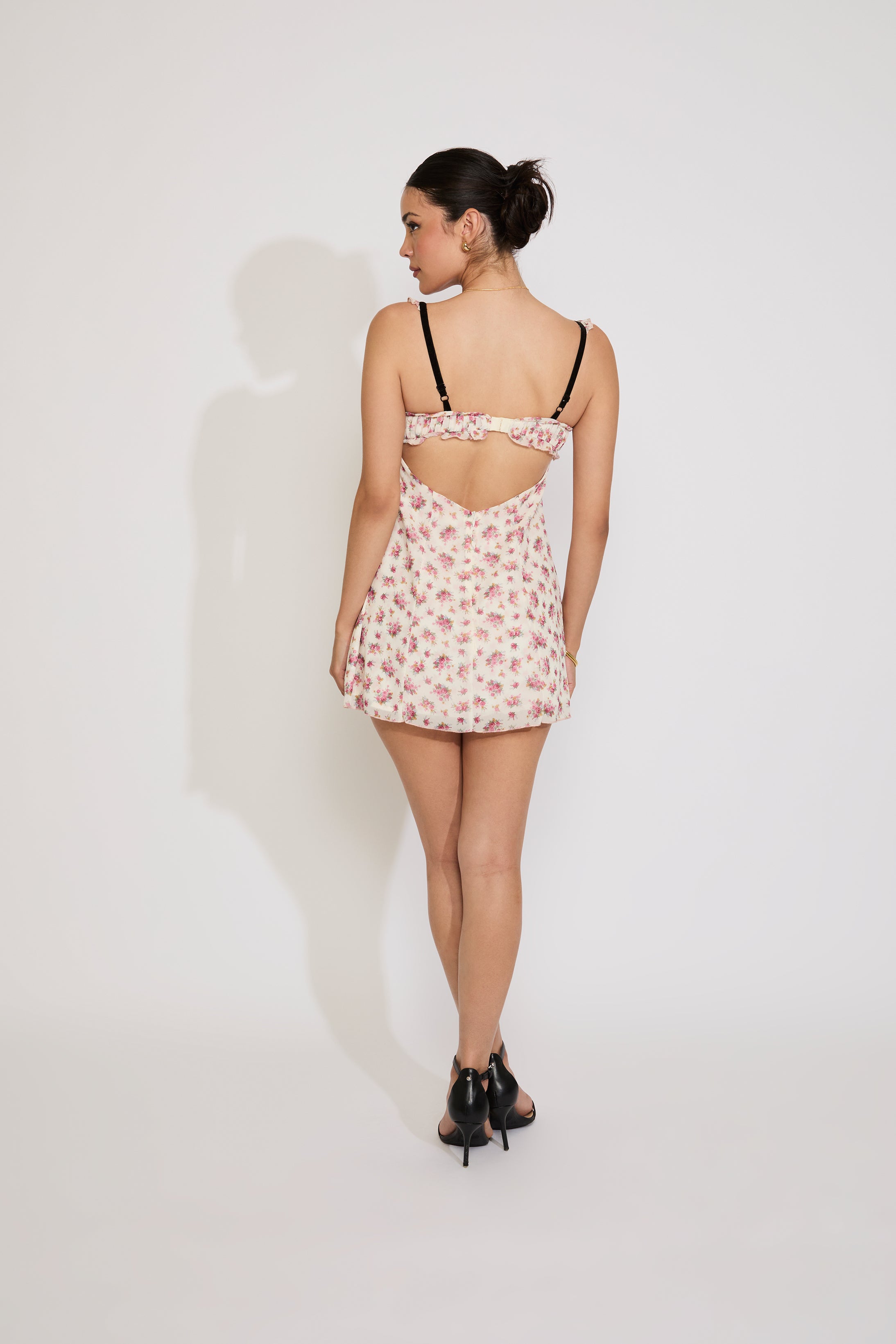 Woman wearing a floral nightgown against a white background