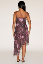 Woman wearing a floral dress with a plain background