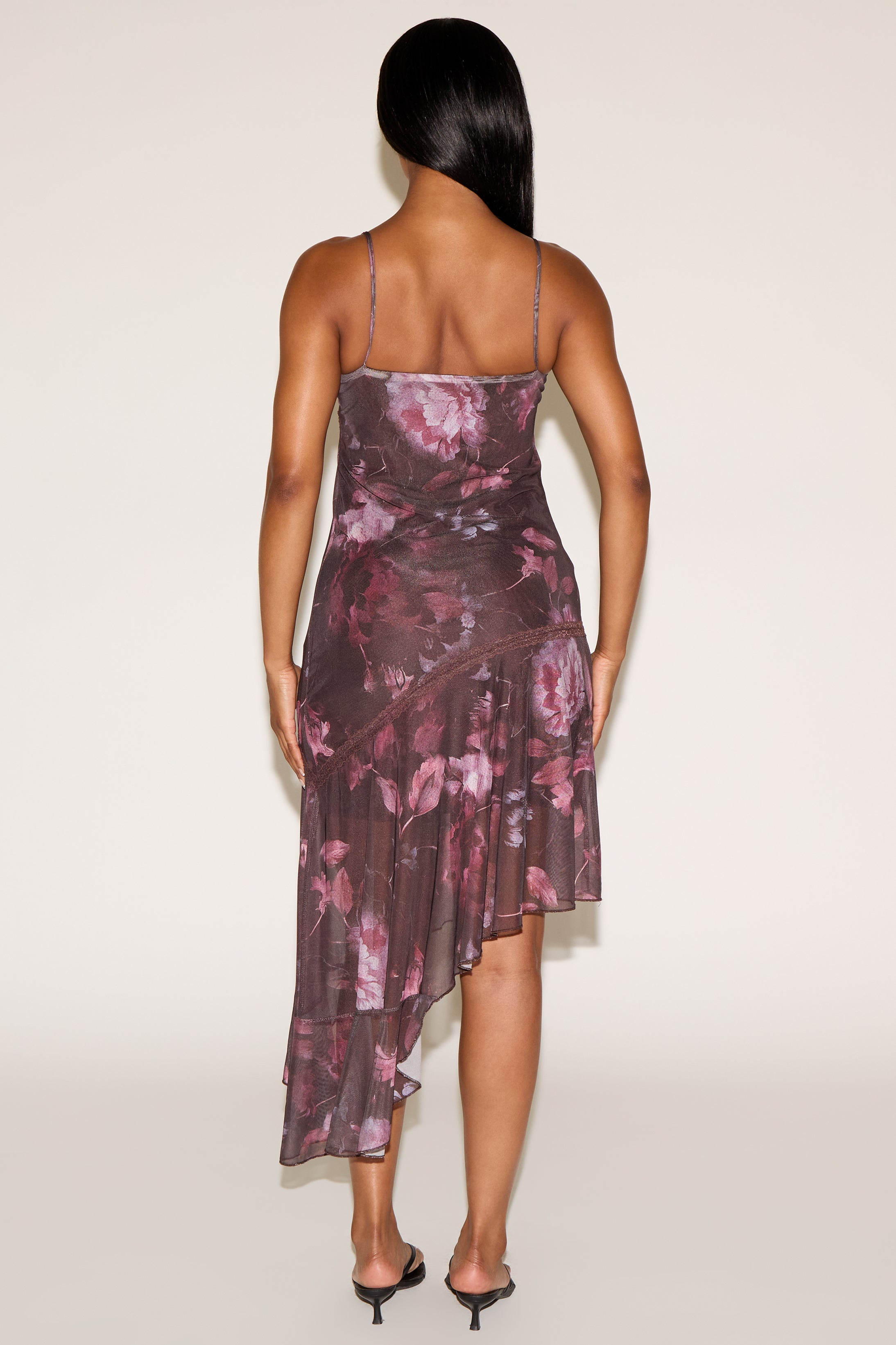 Woman wearing a floral dress with a plain background