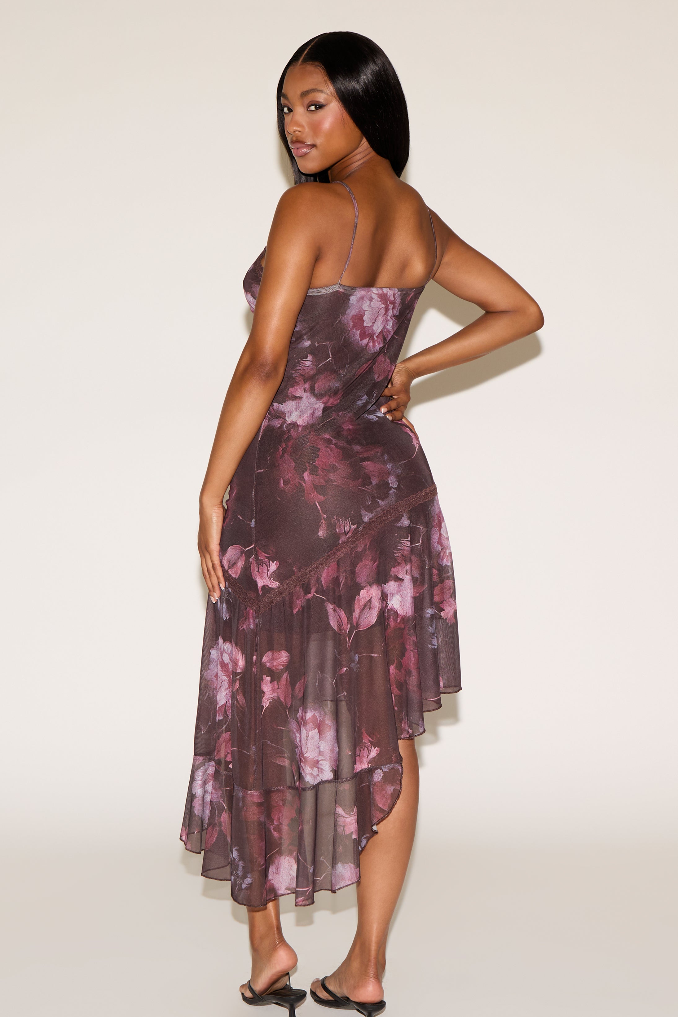 Woman wearing a floral dress with a plain background