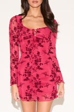 Pink floral dress with long sleeves on a white background