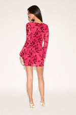 Woman wearing a pink floral dress on a white background