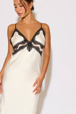 Woman wearing a white satin dress on a white background