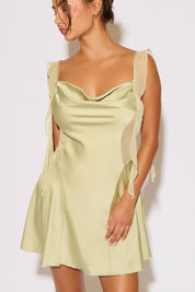 Woman wearing a light green dress against a white background