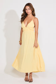 Model is wearing a yellow sleeveless maxi dress on a white background.