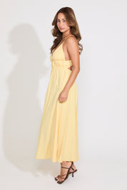Model is wearing a yellow sleeveless maxi dress on a white background.
