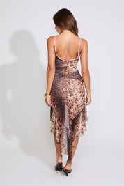 Model is wearing a ANIMAL PRINT HIGH-LOW HEM SLEEVELESS LACE TRIM DRESS with brown heels on a white background.