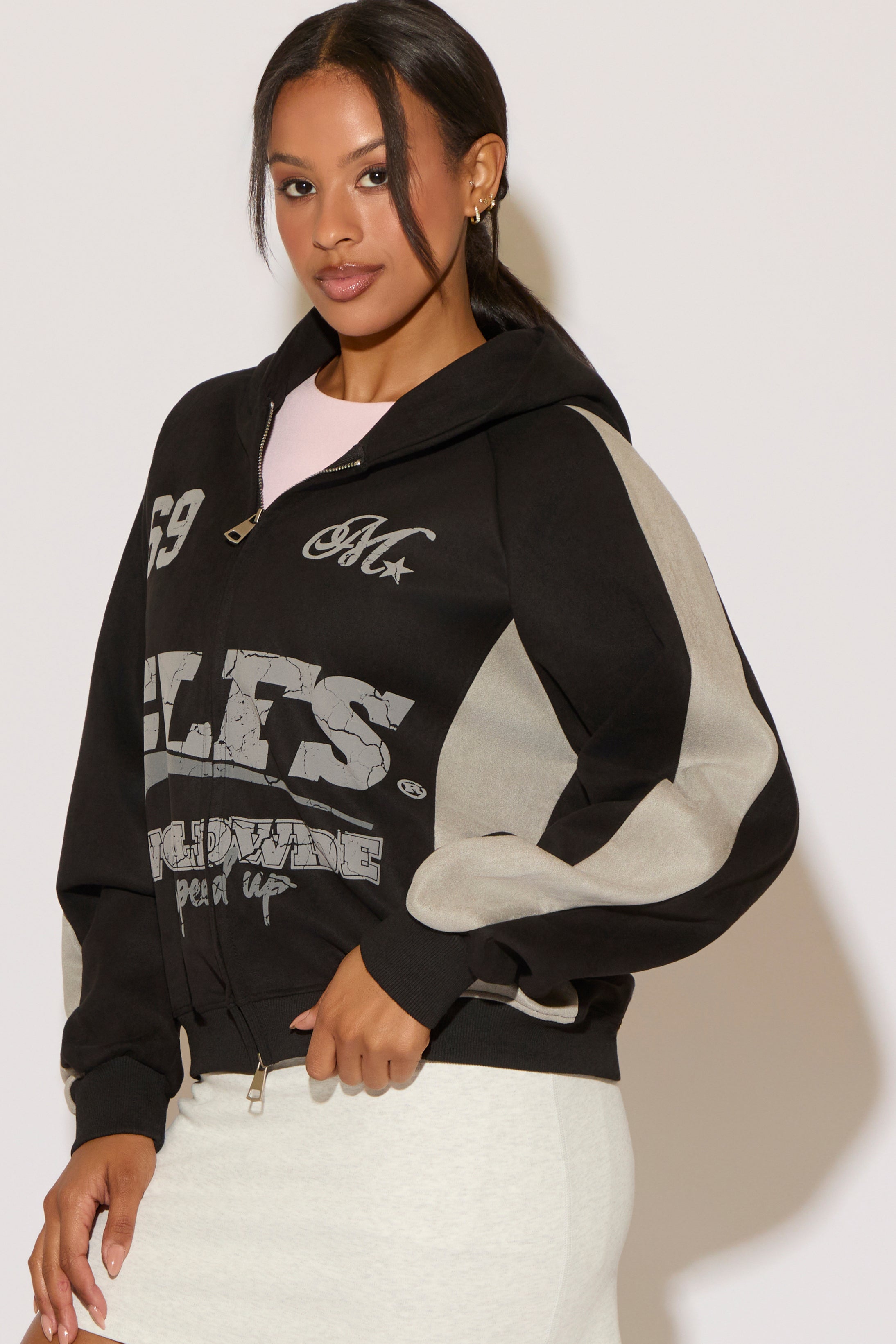 Woman wearing a black and gray hoodie on a white background