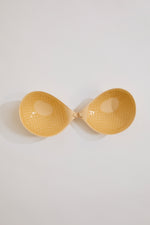 Yellow bra on a light gray background
