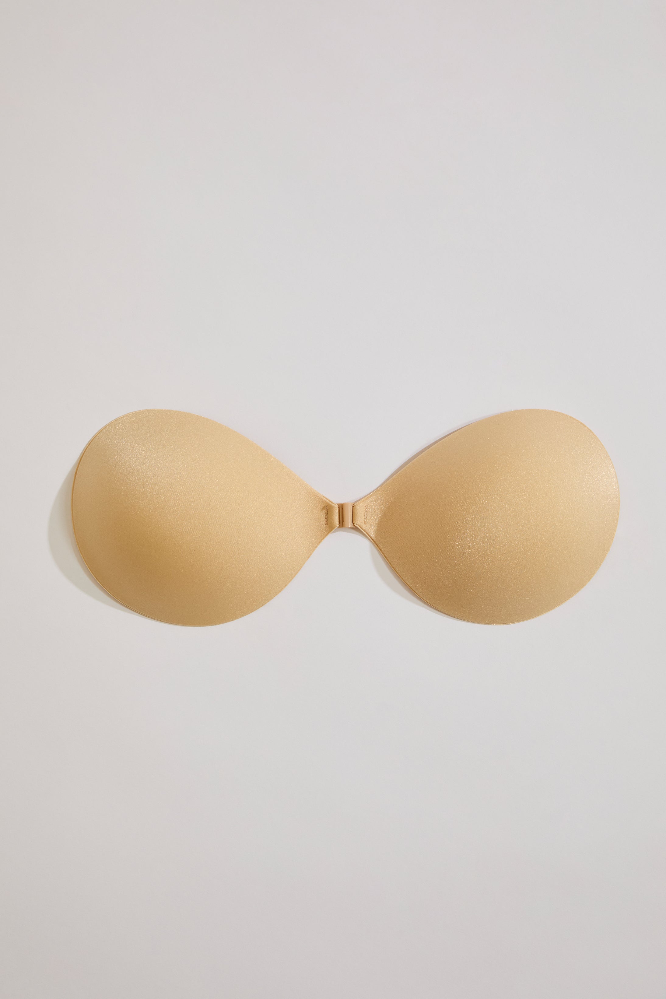 Beige strapless bra on a light gray background