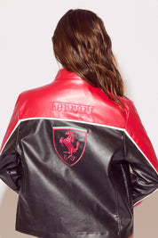 Red and black leather jacket with a logo on the back, worn by a person.