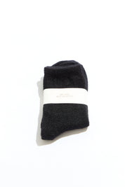 Black socks with a white band on a white background