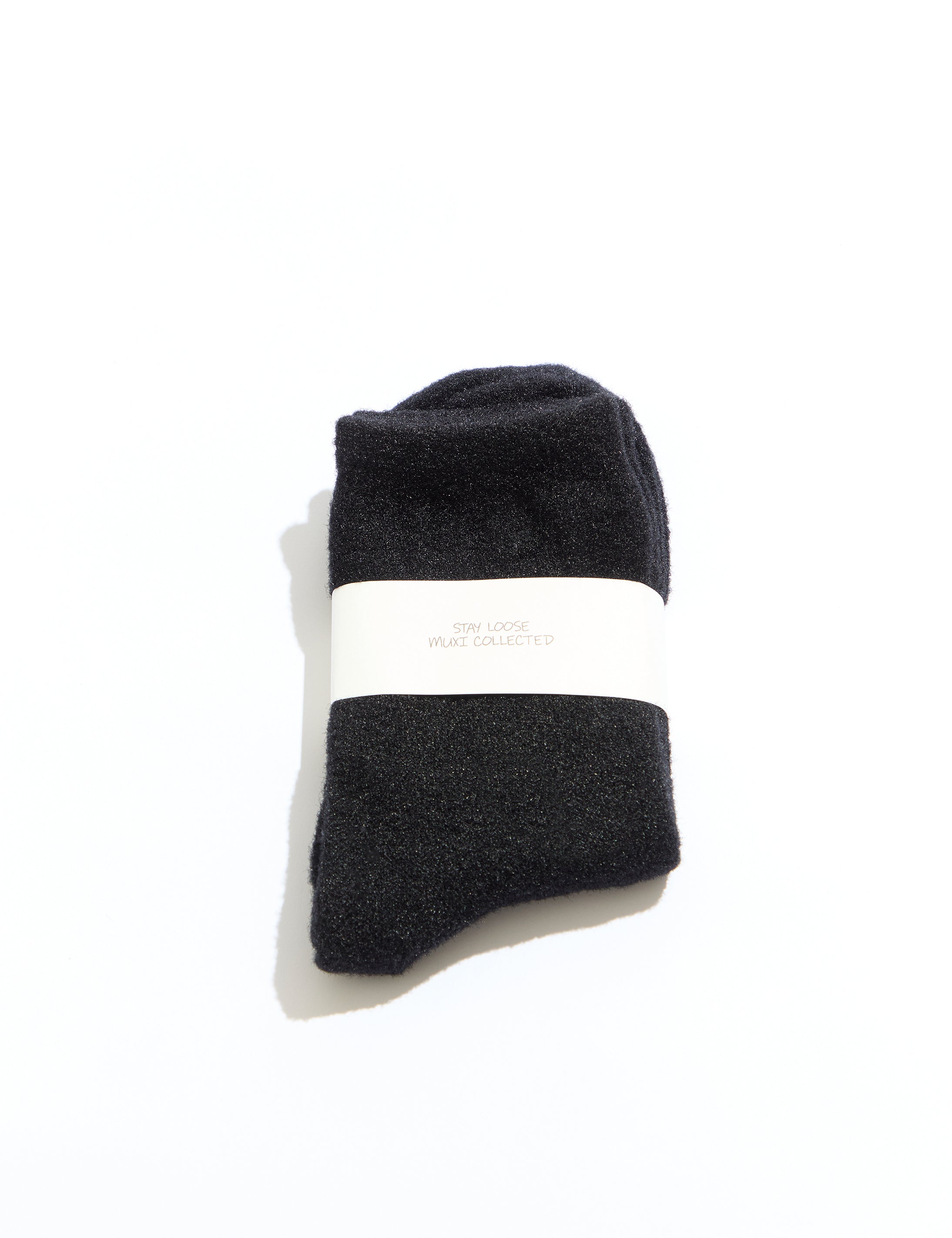 Black socks with a white band on a white background