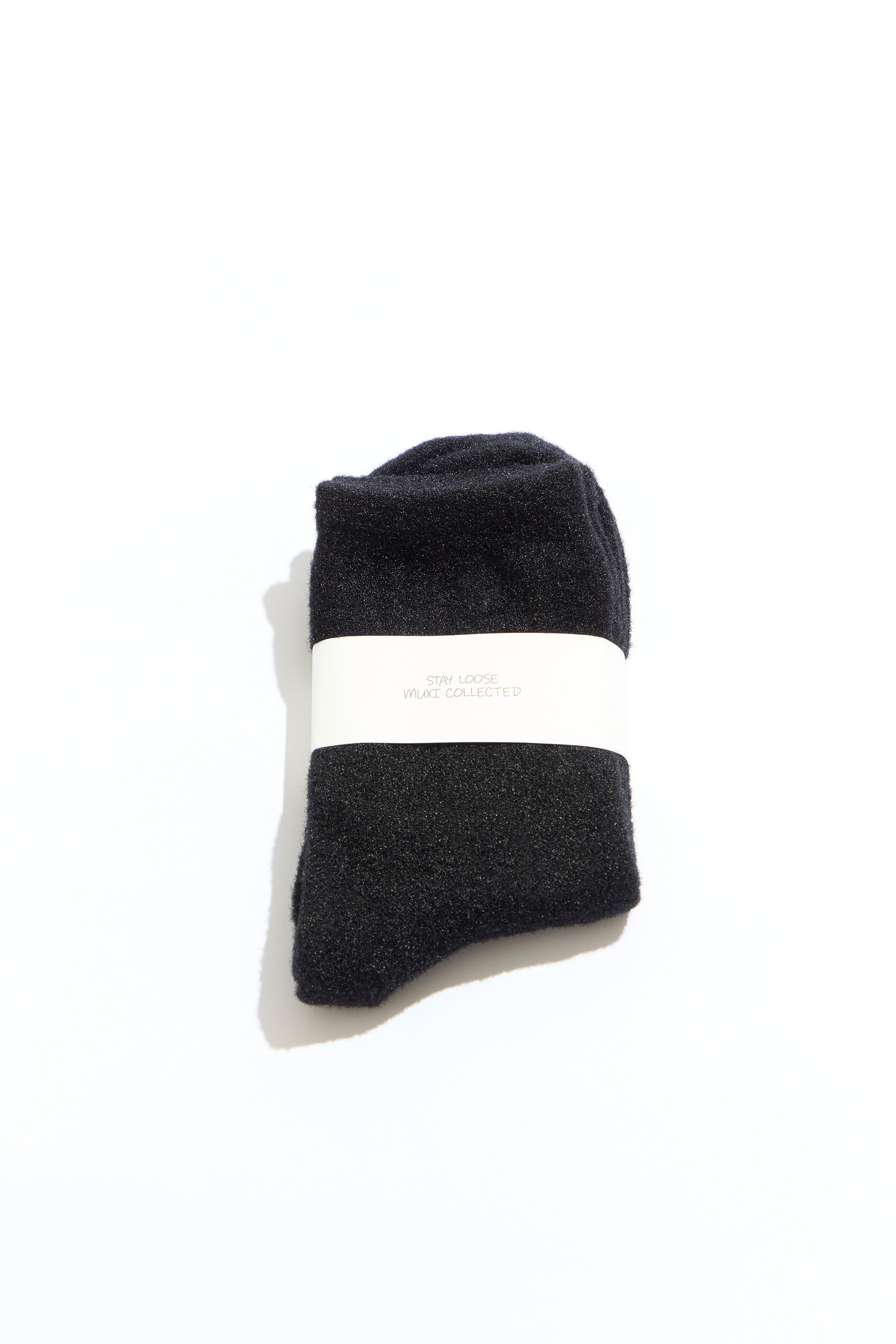 Black socks with a white band on a white background