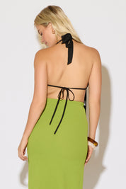 Model is wearing a black bead detail tie neck and back butterfly top with a green maxi skirt on a white background.
