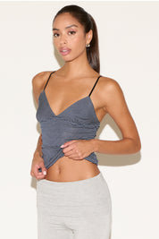 Front view of model wearing a thin strap cami with black and navy stripes.