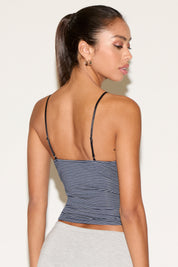 Back view of model wearing a thin strap cami with black and navy stripes.