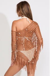 Model is wearing a brown open mesh boat neck poncho on top of a white bikini set on a white background.