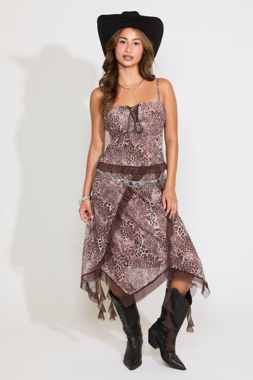 Model is wearing an adjustable strap contrast hem leopard print top with a matching midi skirt on a white background.