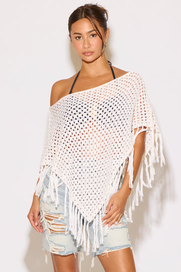Model wearing a white shawl on a white background