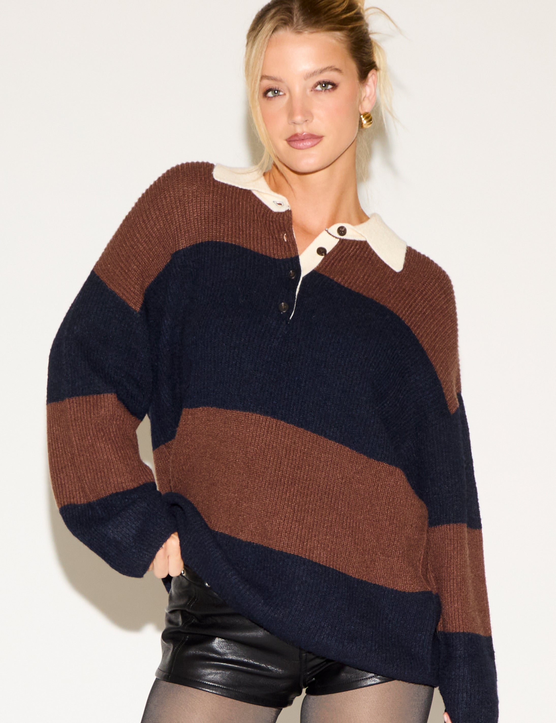 Woman wearing a striped sweater with a white background