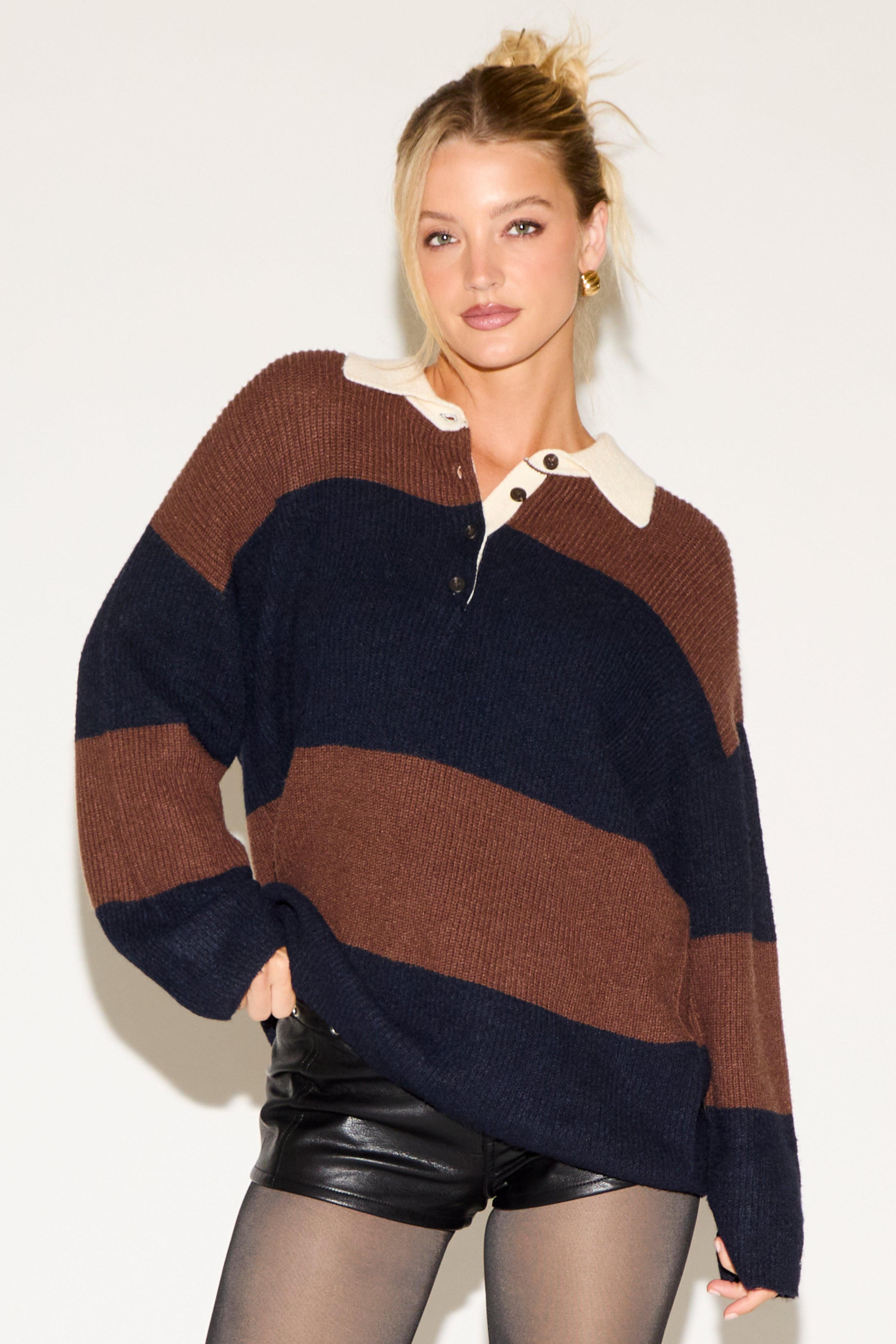 Woman wearing a striped sweater with a white background