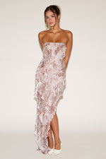 Woman wearing a strapless floral dress on a white background